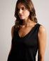SHAVON-Tops-Step up your casual style with this must-have slouchy vest. SHAVON's V-neck and low back provide a comfortable, relaxed fit, while the sleeveless design makes it perfect for layering. The eye-catching embroidered magnolia and contrast stitching add a touch of charm, and the stretch fabric promises all-day comfort. Slouchy vest Rounded V-neck Low back Sleeveless Embroidered magnolia Stretch fabric Contrast stitching Amy is 5'9.5" / 1.77m and wears Black in a Ted size 1- Ted Baker Romania